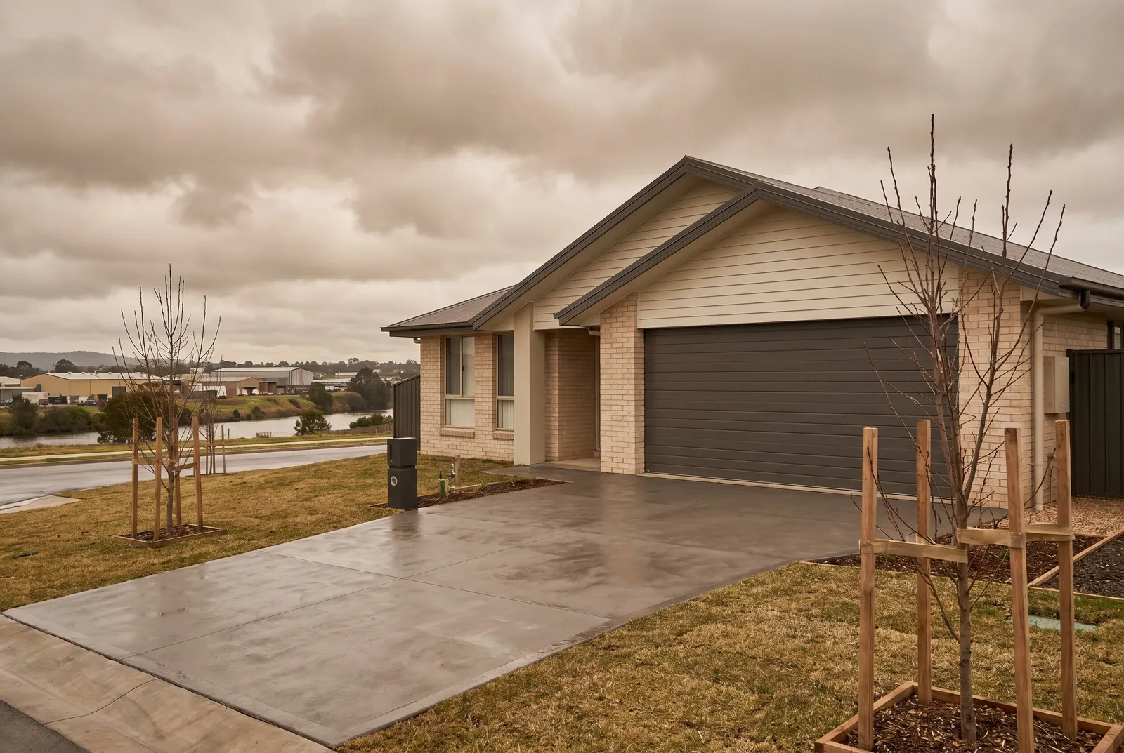 A new estate home with a wide double sectional garage door